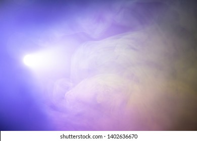 Projector Spotlight Purple Color , Smoke Abstract Texture Background . Light Beam Screening And Glowing For Movie Cinema And Film Multimedia Production In Studio , Freeform Swirl Gas In The Air .