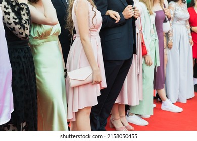 Prom Guests Standing On A Red Carpet, Close Up Photo