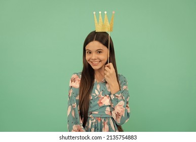 Prom Party. Happy Girl Hold Paper Crown. Prom Queen Blue Background. Contest Winner. Enjoying Photobooth Fun