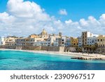 Promenade and beach with people around in the old town of Marsala, Trapani, Sicily, Italy