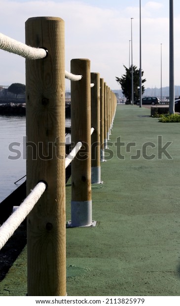 Promenade with wooden poles in\
a row