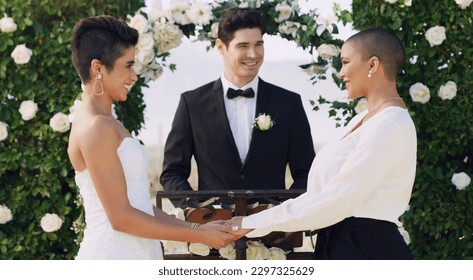 I promise to never let go of your hand. an affectionate young lesbian couple smiling at each other while saying their vows on their wedding day.