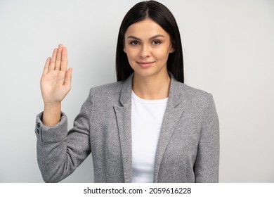 Promise To Tell Truth. Portrait Of Woman Raising Hand To Take Oaths, Promise To Speak Only Truth, Be Sincere And Honest, Trustworthy Evidence. Studio Shot Isolated On White Background 