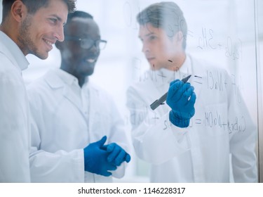 promising scientist makes notes on the Board