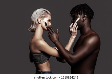 Promoting cosmetics. Two models with different skin colors promoting cosmetics while working together