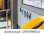 Promoting Inclusive Urban Mobility: A Detailed View of Priority Seating Icons in a City Bus Ensuring Accessibility and Courtesy for All