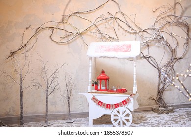 Promotional Counter Cart Outdoors On Christmas Eve. Decorative White Wooden Retro Cart In Garden And Candy Bar In Winter. Street Food Cart. Christmas Market Concept. Christmas And New Year Celebration