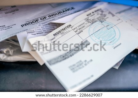 Proof of insurance and vehicle registration documents in the glove compartment of a car.  Stock foto © 