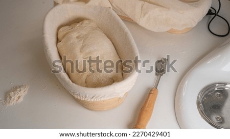 Proofing basket, bannetons bread score on white table
