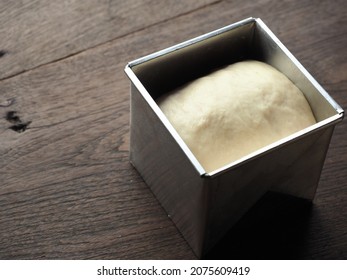 Proofing White Bread Dough In Square Tin Mold On Wooden Table