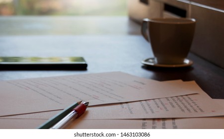 proofreading paper on table with writing hand