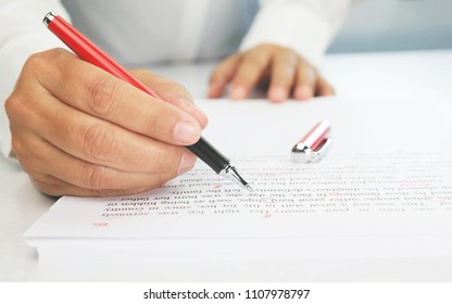 proofreading paper on white table in office