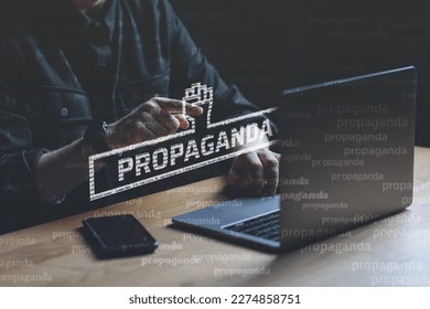 Propaganda visual concept. Man points finger at Propaganda text. High quality photo