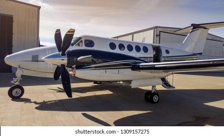 Propeller Airplane Parked Outside Of Hanger