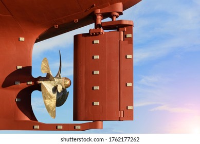 Propeller and rudder of Large cargo ships, aft of ship in floating dry dock yard, completed recondition painting over hull cleaning in dock yard terminal, ready to delivery to the sea services on blue