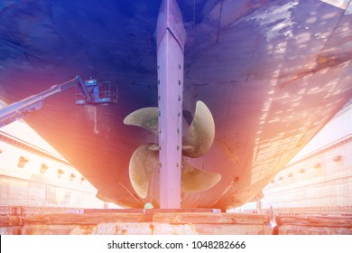 Propeller And Rudder Stern Of Cargo Ship In Shipyard For Maintenance, Color Toned,