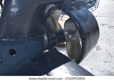 Propeller and tail section of a miniature spy submarine mounted on a pier