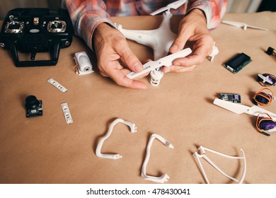 Propellers installing on flying drone, close-up. Building of quadrocopter. Modern technologies, innovation, hobby, aeromodelling concept