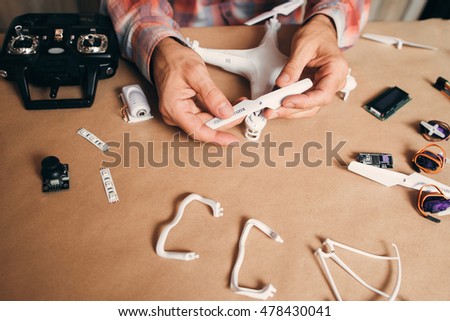 Propellers installing on flying drone, close-up. Building of quadrocopter. Modern technologies, innovation, hobby, aeromodelling concept