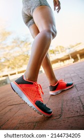 The Proper Footwear Is Important. Low Angle Shot Of An Unrecognizable Athletic Woman Out For A Run In The City.