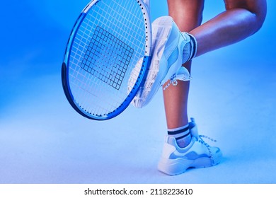 Proper Footwear Is Important. Rearview Shot Of An Unrecognizable Young Female Tennis Player Posing Against A Blue Background.