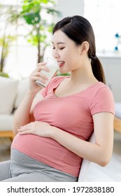 Proper Nutrition Concept - Asian Pregnant Woman Drink A Glass Of Milk