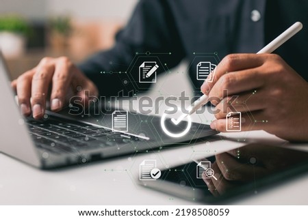 The proper sign for approving an e-document and guaranteeing quality control is made by a businessman using a stylus pen on a digital tablet with a virtual document.