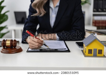 Property Auction Woman's hand holding hammer and model house, real estate lawyer in house sale, finance and foreclosure, ownership concept. [[stock_photo]] © 