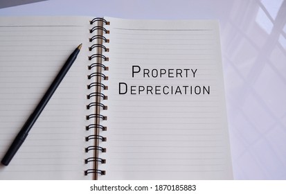 Property Depreciation Text On A Notepad With Reflection Of Window Glass