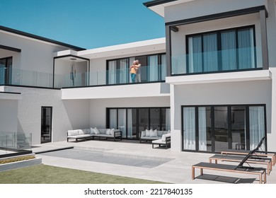 Property, house and senior couple on balcony enjoying sunny day in luxury family home. Retirement, real estate and rich elderly man and woman hugging, embrace and bonding in double story dream home - Powered by Shutterstock