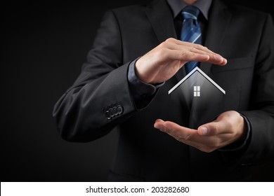 Property insurance and security concept. Protecting gesture of man and symbol of house.