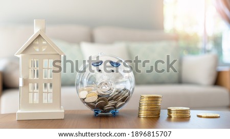Property investment, house mortgage financial planning and real estate home refinancing concept with piggy bank saving budget and money coin stacks
