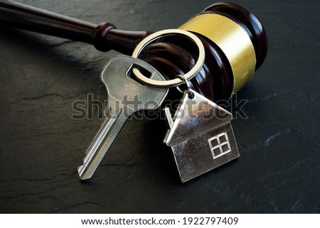 Property litigation and Disputes concept. Key from home and gavel.