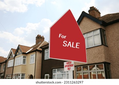 A property sale sign post over some houses. - Shutterstock ID 2311263297