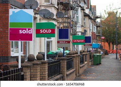 Property Sales. Estate Agents Sold Signs on UK Terraced Houses - Shutterstock ID 1654706968