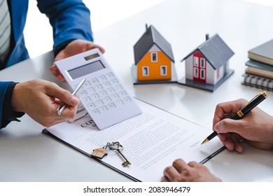 Property Sales Staff Submit Land Mortgage Contract Documents To Home Buyers For A Sign. Business Contract, Lease, Purchase, Mortgage, Loan Or Home Insurance Documents