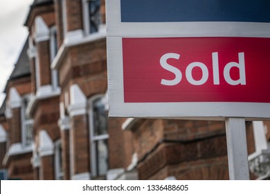 Property 'Sold' sign on urban UK street