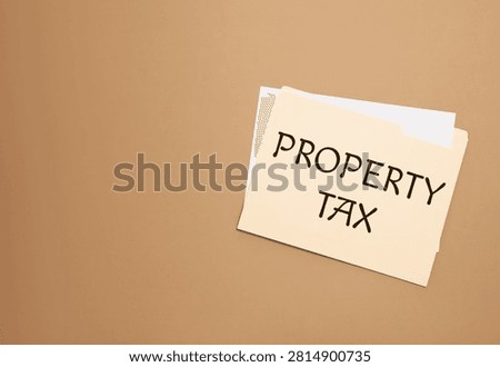 Property tax. Folder with documents on pastel brown background, top view. Space for text