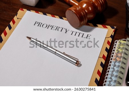 Property Title Document on Envelope with Pen and Gavel Represents Legal Ownership and Transfer Processes in Real Estate Law
