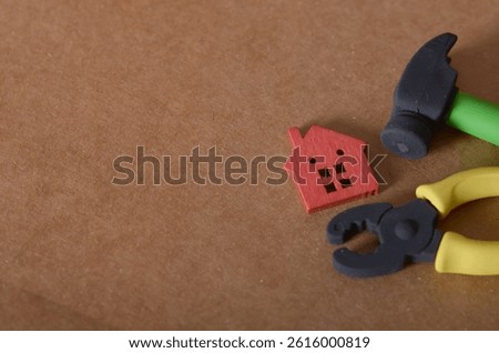 Property Upkeep and Maintenance Theme with Tiny Red House and Repair Tool