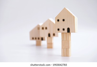 Property Value And Asset Increase Concept. Residential Price Growth. Investment In The Real Estate Market. Home Appraisals Cost. House Valuation. Wooden House Models With Stacks Of The Block.