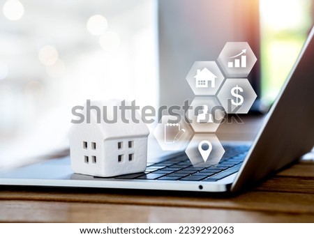 Property value, home investment, real estate online market and house selection concepts. Property valuation diagram with icons virtual near white miniature house on laptop computer with copy space.