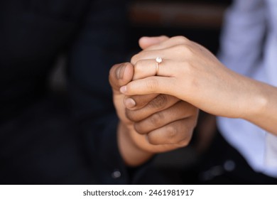 proposal close up, fiancé holding hands showing the engagement ring on the finger hand of young woman - Powered by Shutterstock