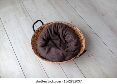 Props For Newborn Photo. Digital Backdrop. Wicker Basket On A Light Wooden Background. Brown Cloth. Backstage. 