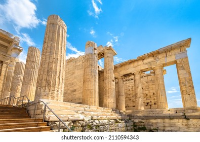 Propylaea on Acropolis of Athens, Greece, Europe. This ancient entrance to Acropolis is famous landmark of Athens. Classical Greek architecture of Athens. Antique ruins in Athens city center. - Shutterstock ID 2110594343