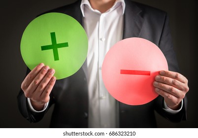 Pros and cons concept. Business man with cardboard plus and minus symbol signs. - Shutterstock ID 686323210