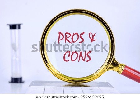 PROS and CONS message Close-up through a magnifying glass, conceptual photo.
