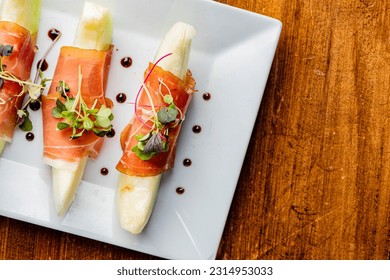 Prosciutto and Melon. Charcuterie platter. Assortment on cured and salted deli meats and cheeses, pastrami, salami, prosciutto served with olives and fruits. Classic traditional party favorite.   - Shutterstock ID 2314953033