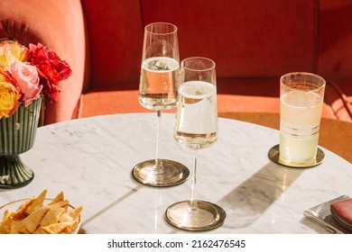 Prosecco flutes and snacks on a marbel table 