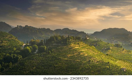 Prosecco Hills, vineyards and San Lorenzo church and Credazzo Towers at sunrise. Unesco Site. Farra di Soligo. Veneto, Italy, Europe.